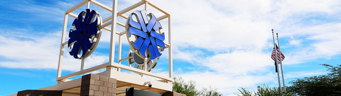 An outside image of the Pima Logo tower at Pima East Campus